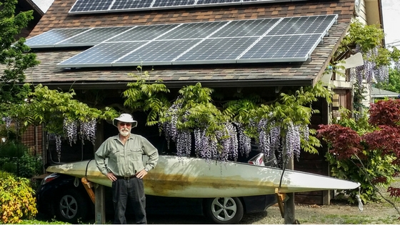 Happy Homeowner Posing in Front of His Residential Solar Power System